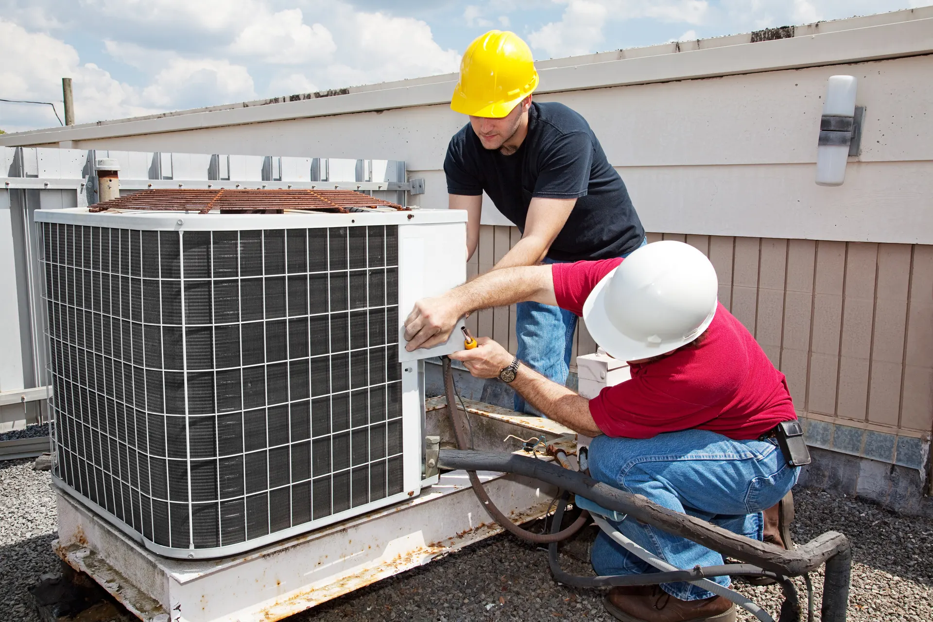 Technician repairing an air conditioner unit