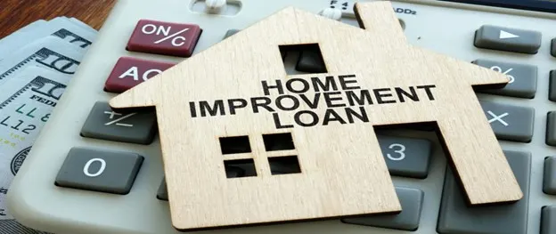 Home improvement loan — house model on a calculator